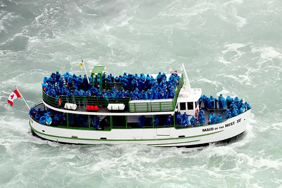 Maid of the Mist boat taking tourist on a wet and wild ride under waterfall