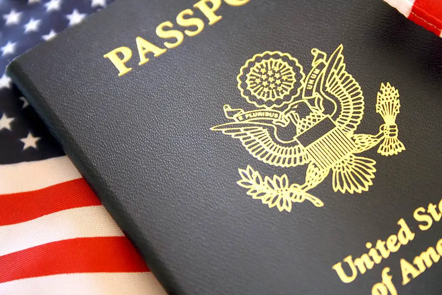 American flag with United States passport laying on top
