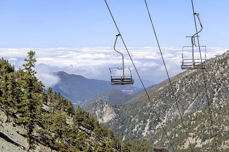 Ski lift with view of rugged mountains and trees