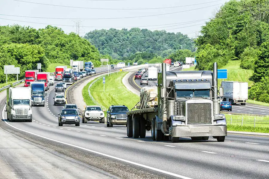 Traffic on busy interstate highway as it winds through forested hills