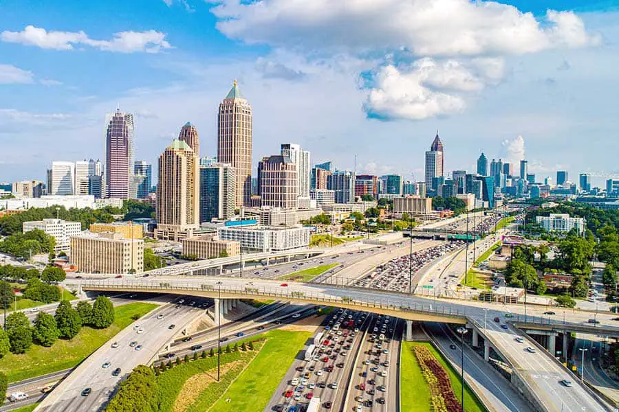 Aerial view of crowded highway leading into Atlanta Georgia, skyscrapers dot the horizon