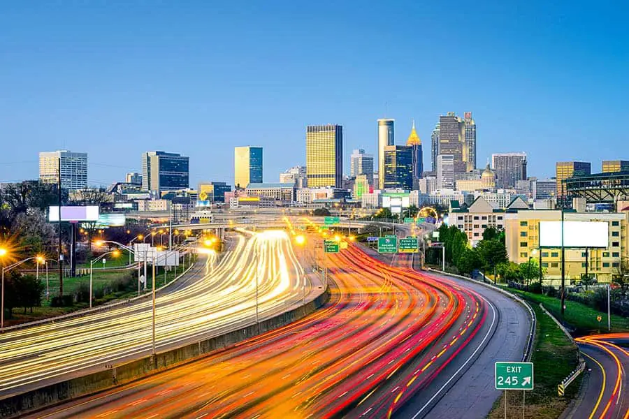 Time lapse photo of Atlanta traffic with city skyscrapers on the horizon