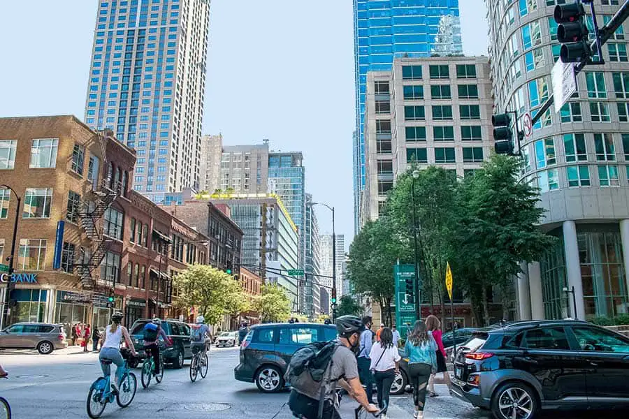 Bicyclists and pedestrians maneuver through traffic