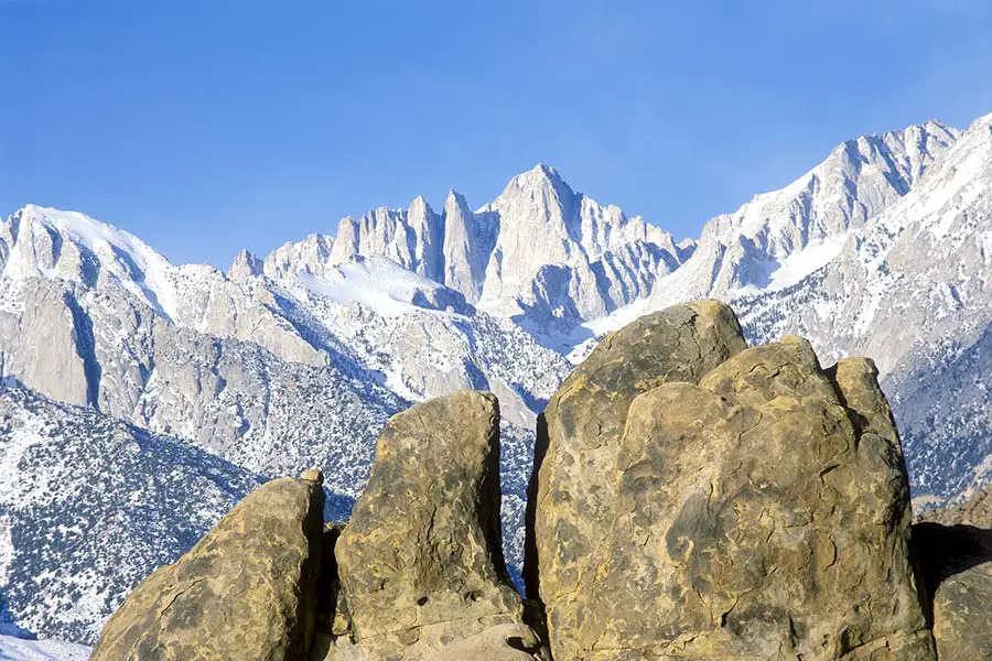 Beautiful view of rugged snow covered mountains, huge boulders in the foreground