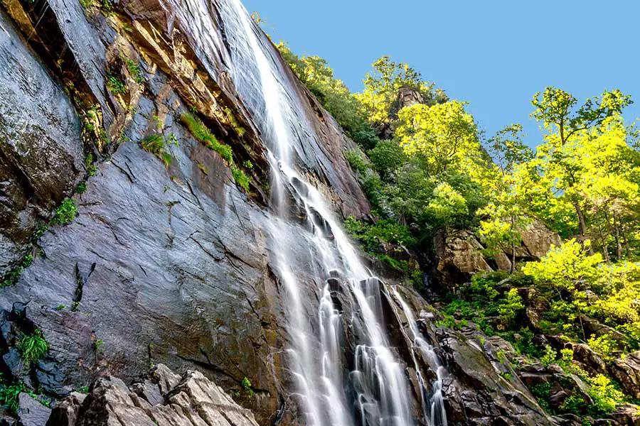 Water cascades over rocky Hickory Nut Falls in North Carolina