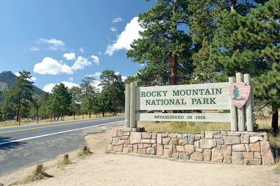 Rocky Mountain National Park entrance sign, established in 1915 beautiful sunny day