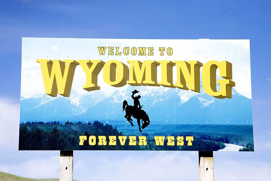 Welcome to Wyoming, forever west with man on bucking horse