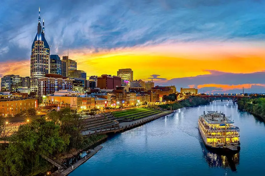 Aerial view of Nashville Tennessee skyline, paddle wheel boat on river at sunset